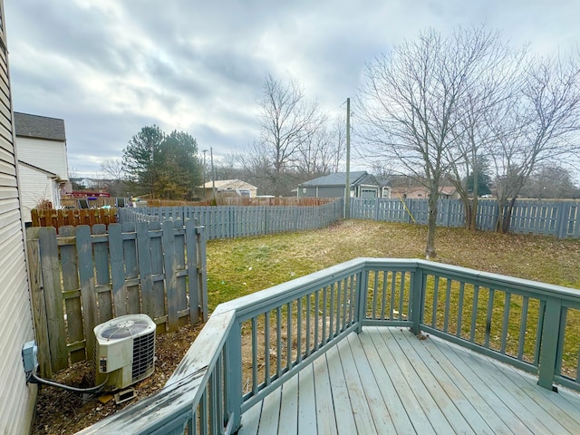 wooden terrace featuring a lawn and central air condition unit