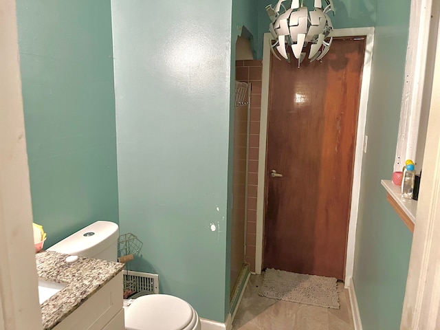 bathroom with vanity, toilet, and walk in shower