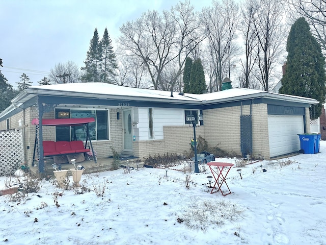 view of front of property with a porch and a garage