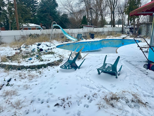 snow covered pool featuring a water slide