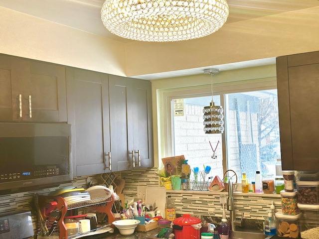 kitchen featuring backsplash and a notable chandelier