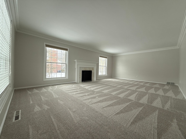 unfurnished living room featuring carpet and ornamental molding