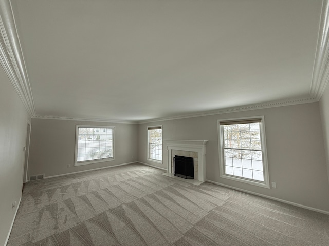 unfurnished living room with a fireplace, light carpet, and ornamental molding