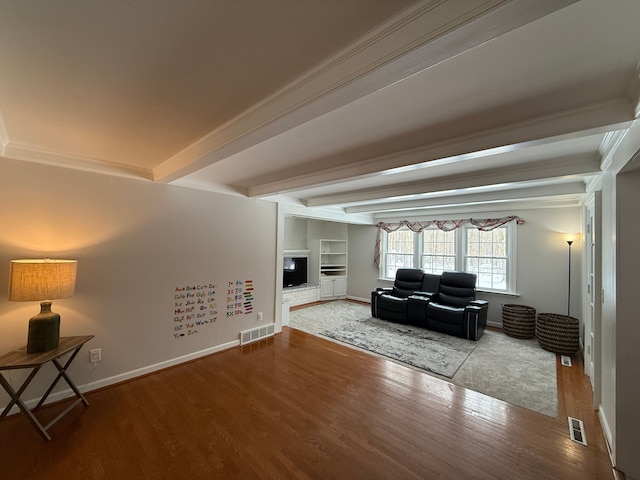 living room featuring beam ceiling, built in features, crown molding, and hardwood / wood-style floors