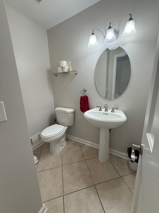 bathroom with tile patterned floors and toilet