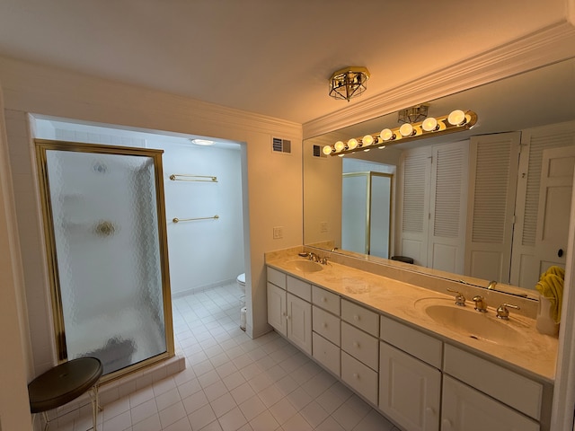 bathroom featuring a shower with door, ornamental molding, and toilet