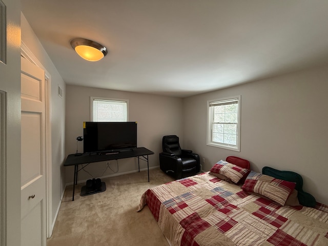 bedroom featuring light carpet