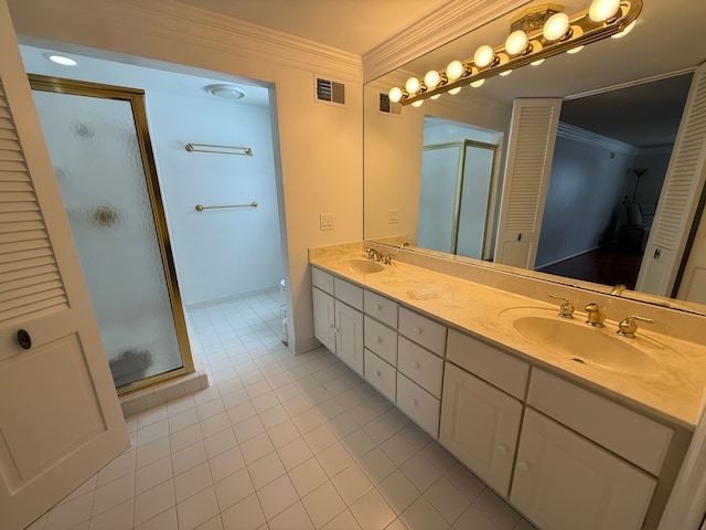 bathroom featuring vanity, tile patterned floors, a shower with door, and ornamental molding