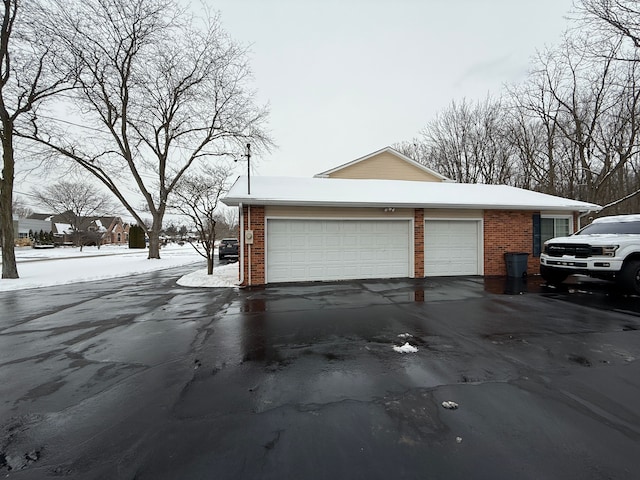 view of snow covered exterior with a garage