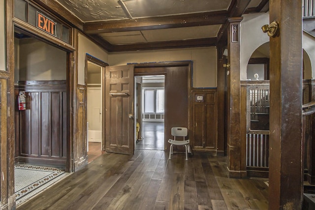 hallway with dark wood-type flooring and beam ceiling