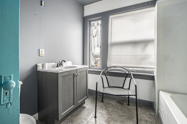 bathroom with a bathing tub and vanity