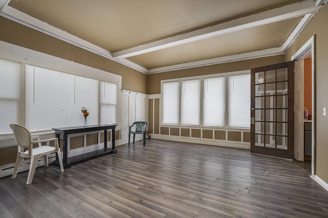 sitting room featuring baseboard heating, ornamental molding, dark hardwood / wood-style floors, and beamed ceiling