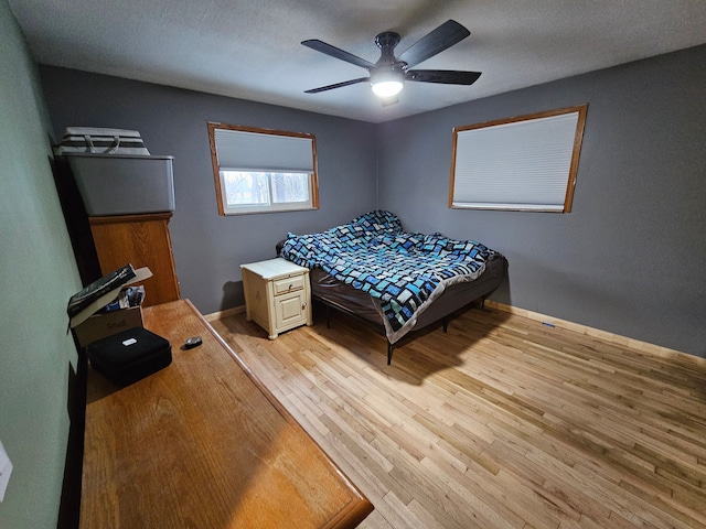 bedroom with ceiling fan and light wood-type flooring