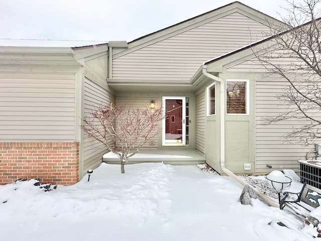 view of snow covered property entrance