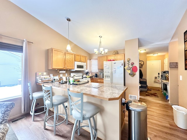 kitchen with light wood-type flooring, white appliances, decorative light fixtures, a notable chandelier, and lofted ceiling