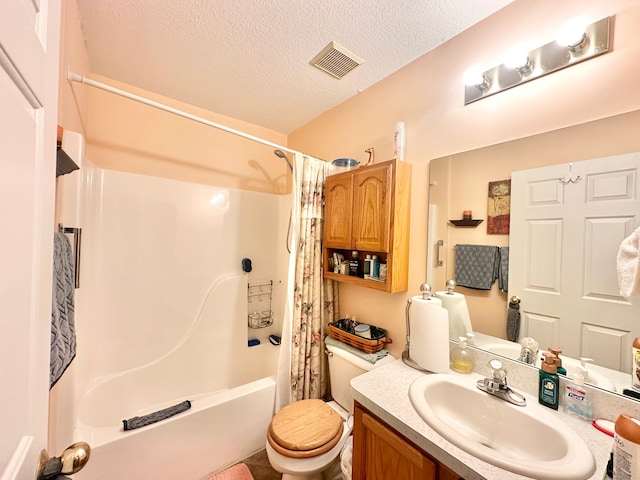 full bathroom with shower / tub combo with curtain, vanity, a textured ceiling, and toilet