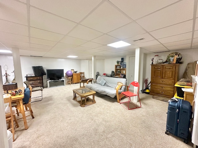 carpeted living room with a drop ceiling