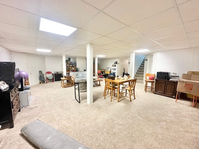 interior space featuring a paneled ceiling and light colored carpet