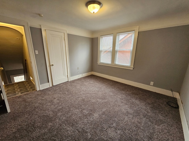 unfurnished bedroom with crown molding and carpet flooring