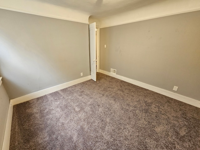 empty room featuring carpet floors and ornamental molding