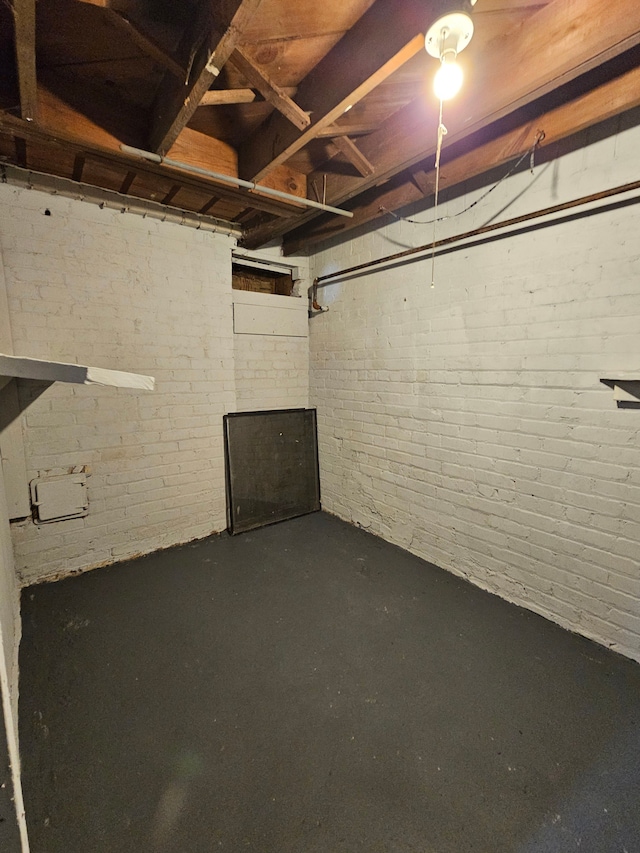 basement with brick wall