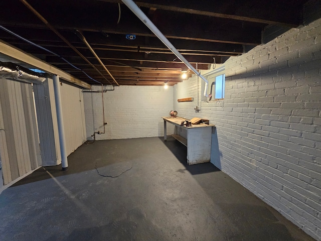 basement featuring brick wall