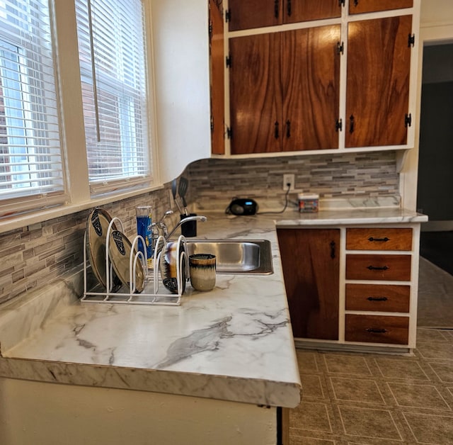 kitchen featuring tasteful backsplash and sink