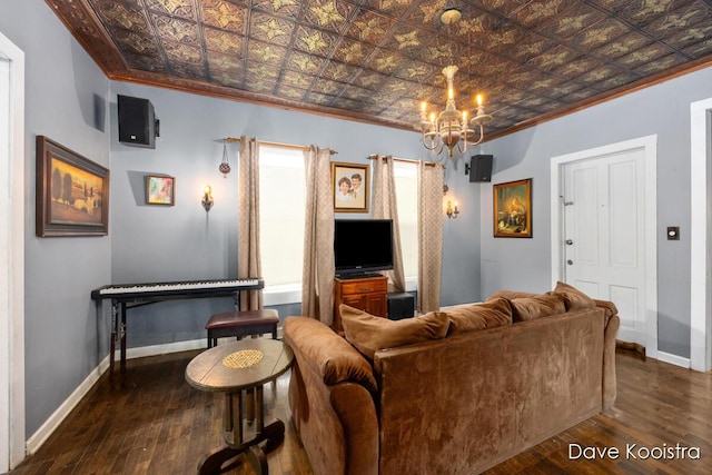 living room featuring ornamental molding, a notable chandelier, and dark wood-type flooring