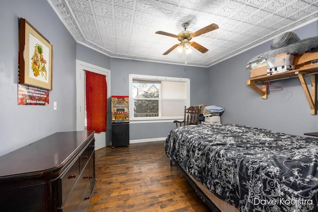 bedroom featuring ornamental molding, ceiling fan, and dark hardwood / wood-style floors