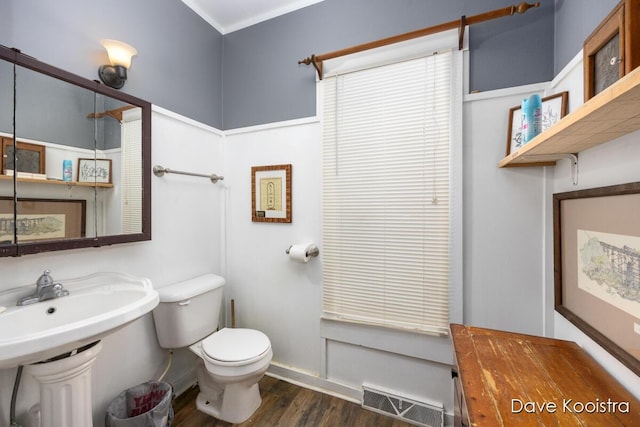 bathroom featuring toilet and wood-type flooring