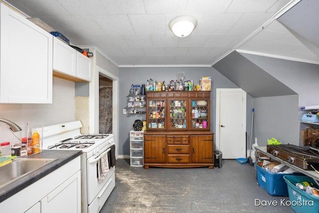 kitchen featuring sink, ornamental molding, white cabinetry, and white gas stove