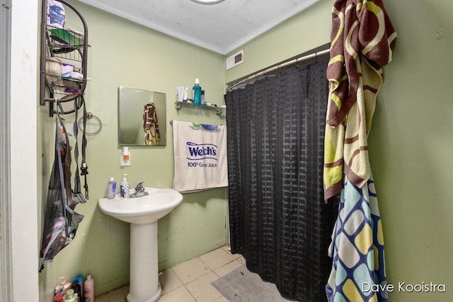 bathroom with ornamental molding, walk in shower, tile patterned flooring, and sink