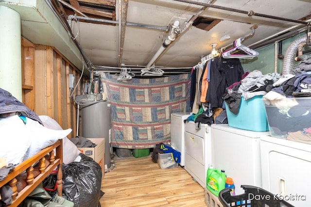 washroom with separate washer and dryer, gas water heater, and wood-type flooring