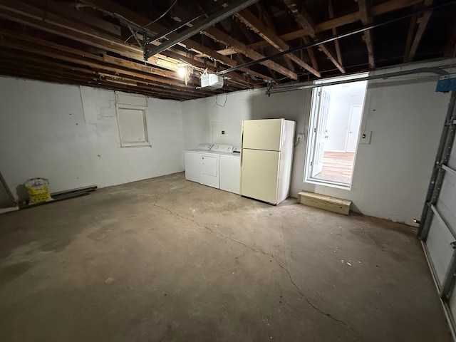 basement featuring white fridge and washing machine and dryer