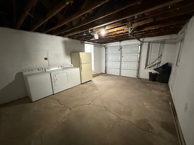 garage with washer and dryer and white fridge