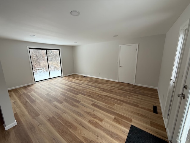 empty room with light hardwood / wood-style floors