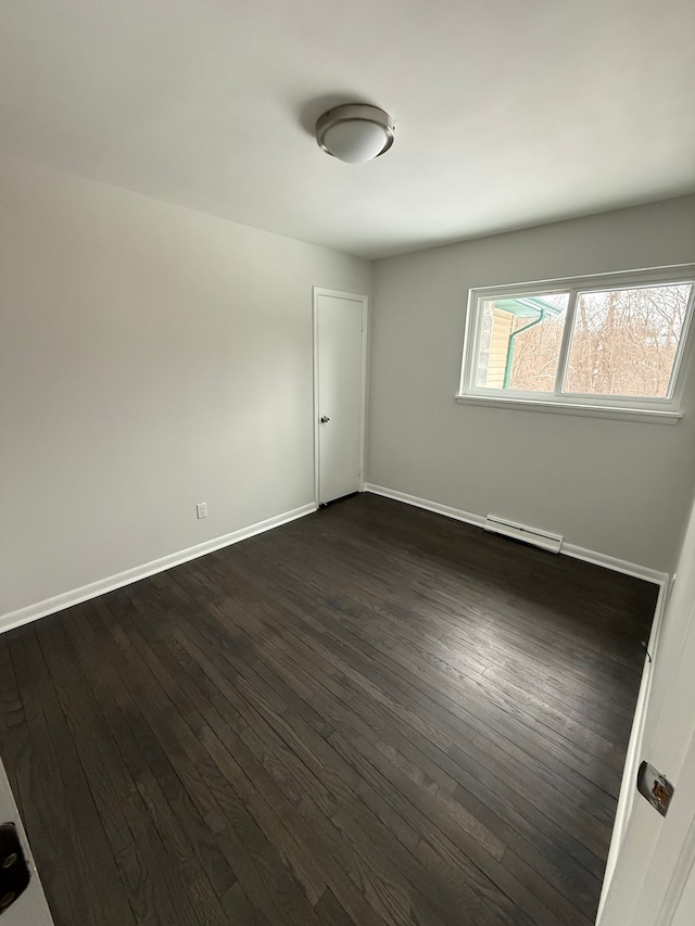 unfurnished room featuring dark wood-type flooring