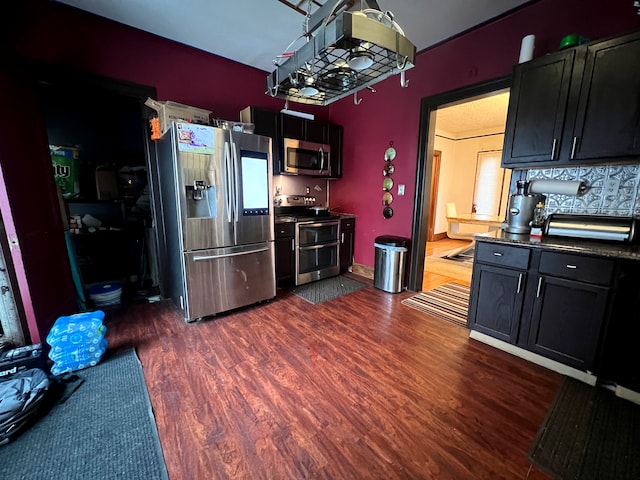 kitchen with dark wood-type flooring and appliances with stainless steel finishes