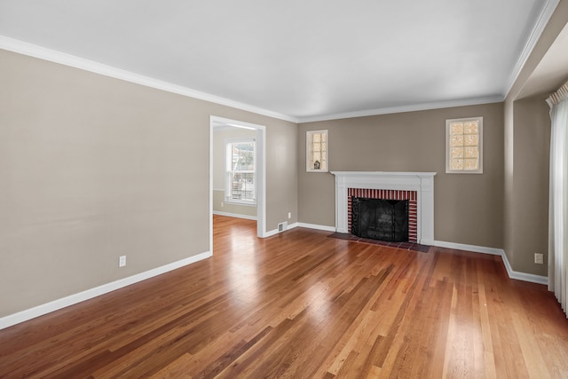 unfurnished living room with crown molding, hardwood / wood-style flooring, and a fireplace