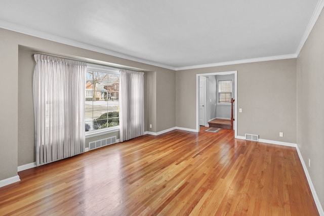 unfurnished room featuring a wealth of natural light, crown molding, and light hardwood / wood-style floors