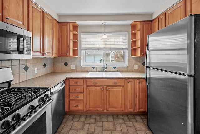 kitchen with sink, tasteful backsplash, pendant lighting, and stainless steel appliances