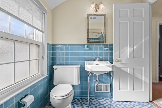 bathroom featuring sink, tile walls, toilet, and tile patterned flooring