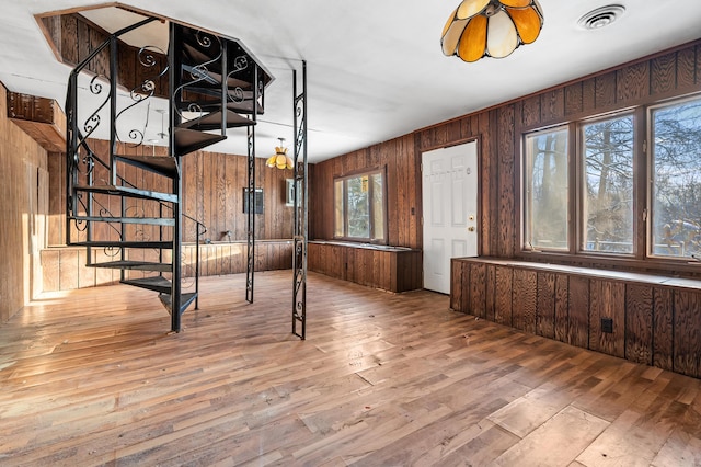 interior space featuring hardwood / wood-style floors and wood walls