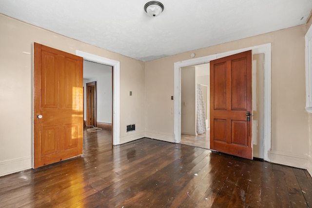 spare room featuring dark hardwood / wood-style flooring