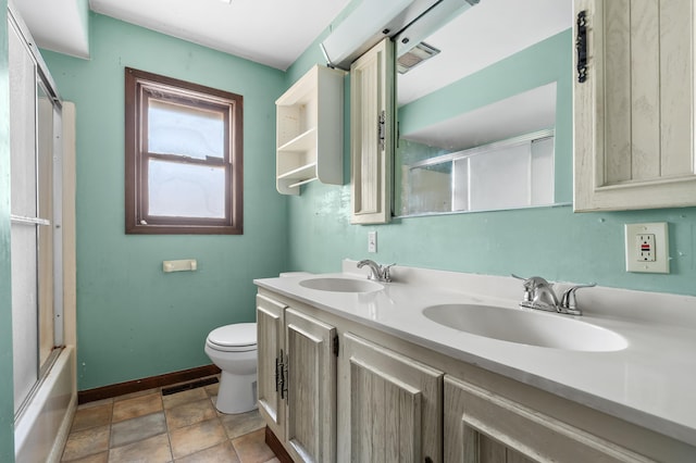 full bathroom featuring toilet, vanity, and combined bath / shower with glass door