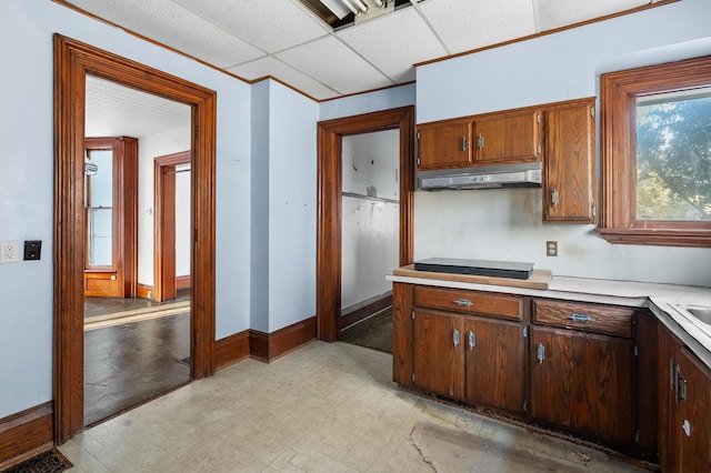 kitchen featuring a paneled ceiling and black stovetop