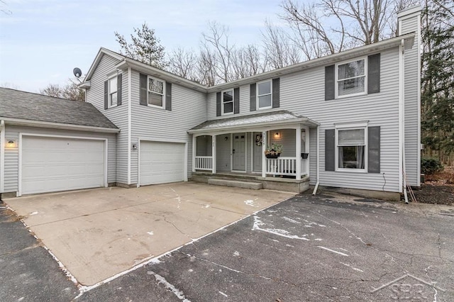 front of property featuring covered porch and a garage