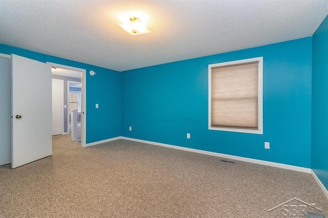 empty room with a textured ceiling