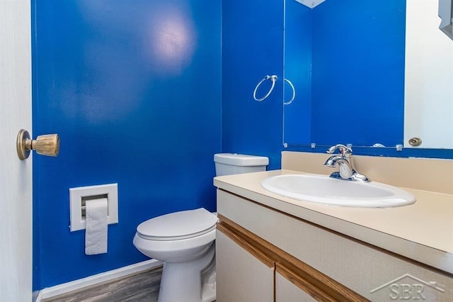 bathroom featuring hardwood / wood-style floors, vanity, and toilet