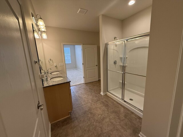 bathroom featuring vanity and an enclosed shower